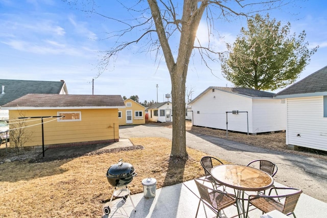 view of yard with an outbuilding and a patio area