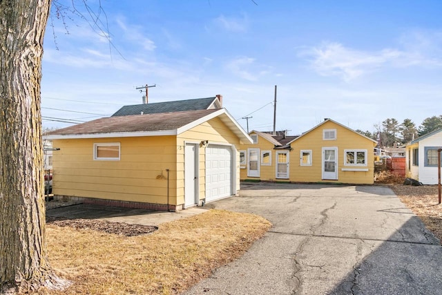 detached garage featuring driveway