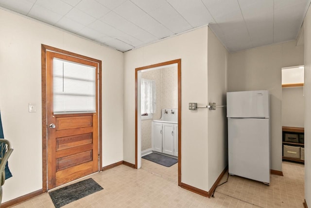 doorway to outside with baseboards