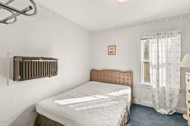 bedroom featuring baseboards and carpet floors