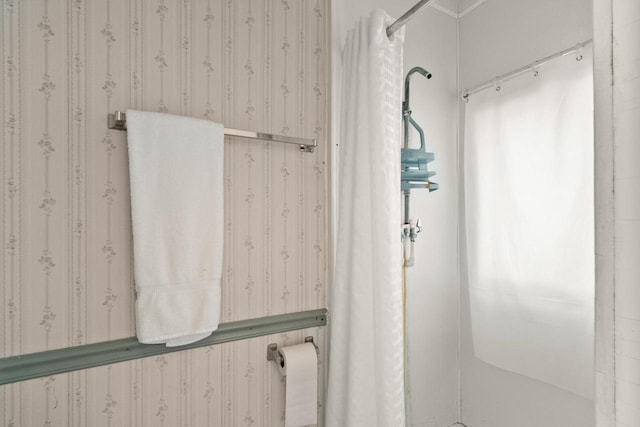 bathroom with wallpapered walls