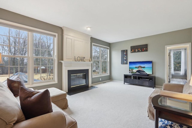 living area featuring baseboards, carpet floors, and a fireplace