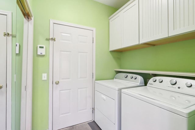 laundry room with cabinet space and separate washer and dryer