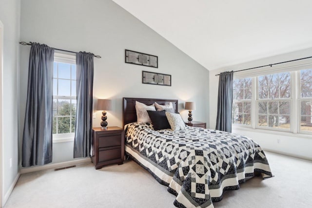 bedroom with baseboards, carpet, visible vents, and high vaulted ceiling