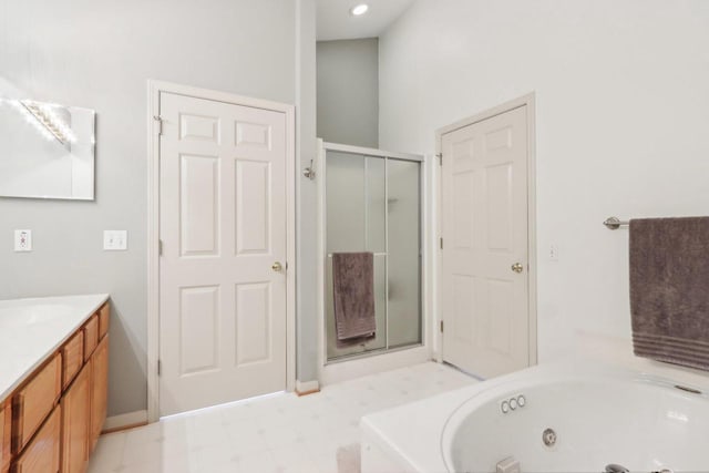 full bathroom featuring tile patterned floors, vanity, a whirlpool tub, and a shower stall