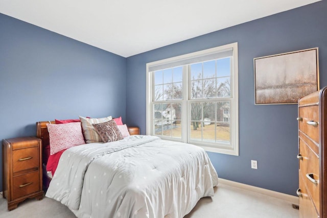 carpeted bedroom featuring baseboards