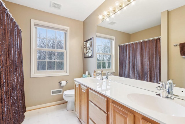 full bathroom featuring toilet, visible vents, and a sink