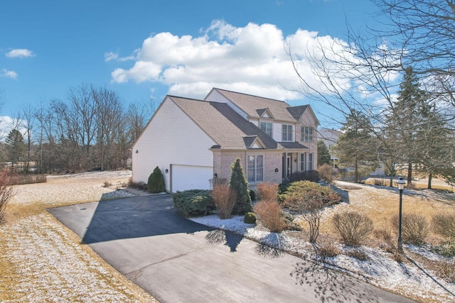 view of front of property featuring brick siding and driveway