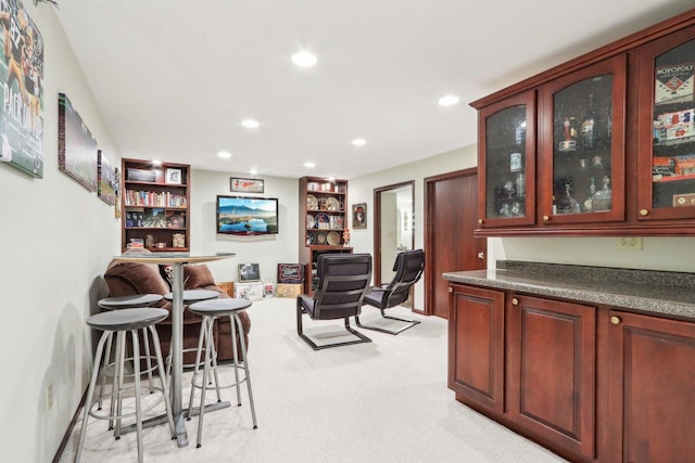 living area featuring recessed lighting and light colored carpet