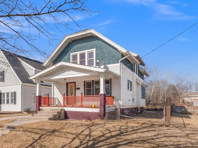 view of front of home with covered porch and fence