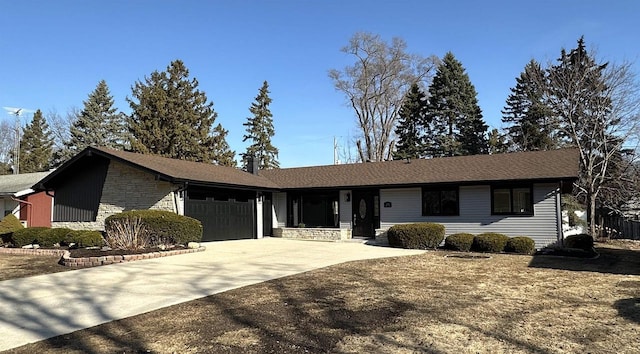 ranch-style home featuring stone siding, concrete driveway, and a garage