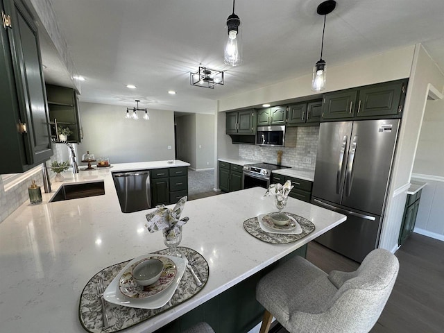 kitchen with light stone counters, a peninsula, stainless steel appliances, a kitchen breakfast bar, and backsplash