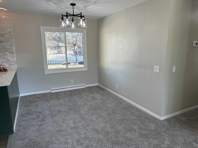 unfurnished dining area with a baseboard heating unit, carpet floors, and baseboards