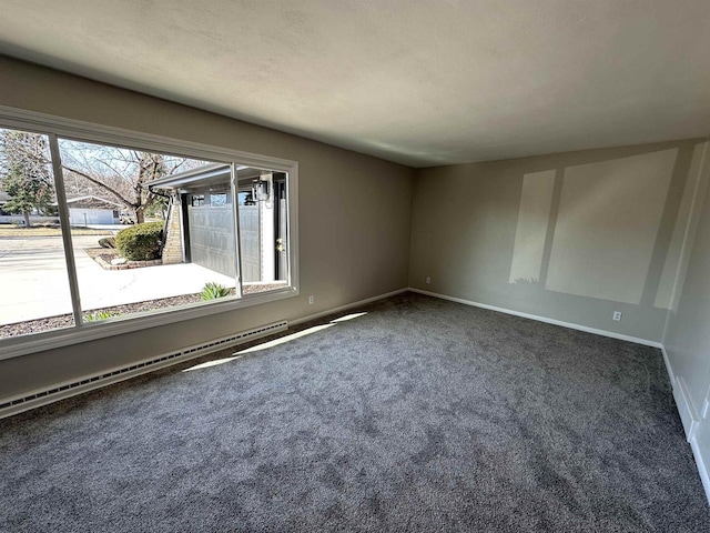 unfurnished room featuring carpet, baseboards, and baseboard heating