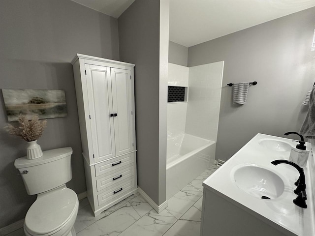 full bath featuring toilet, baseboards, marble finish floor, and a sink