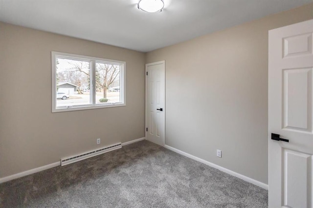 carpeted spare room featuring baseboards and a baseboard radiator