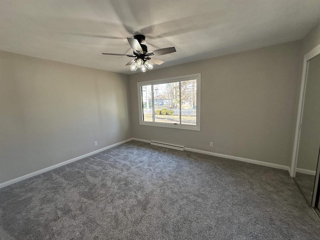 spare room featuring a ceiling fan, baseboards, dark colored carpet, and a baseboard radiator