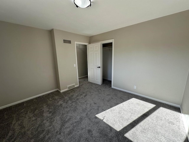 unfurnished bedroom featuring visible vents, baseboards, and a closet