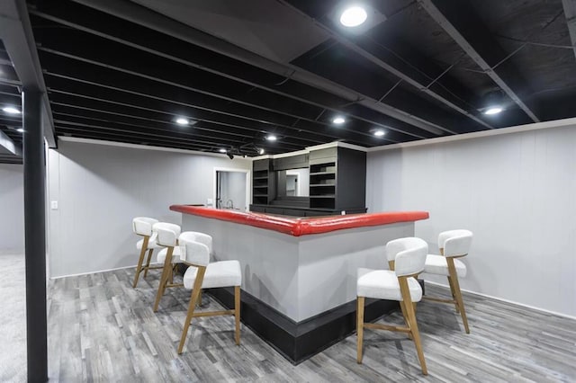 bar featuring wet bar and wood finished floors