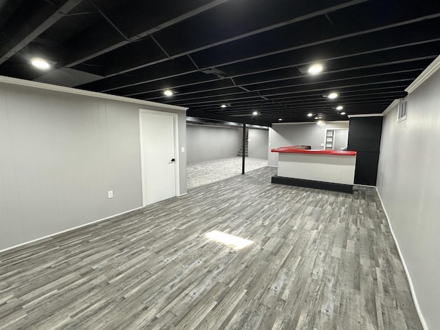 finished basement with baseboards and wood finished floors