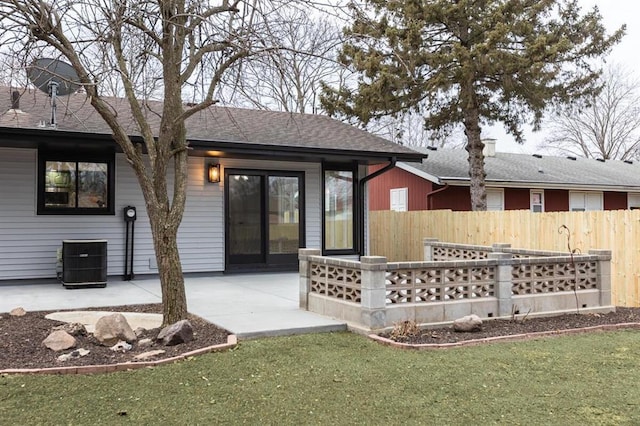 back of property with a shingled roof, central AC, a patio, and fence