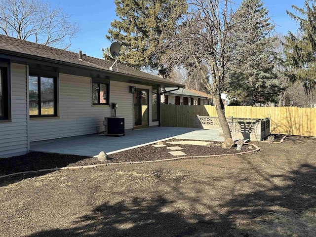 exterior space featuring central AC unit, a patio area, and fence