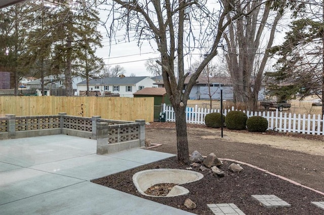 view of patio / terrace featuring fence and a residential view