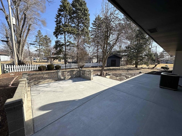 view of patio with a fenced backyard, a storage shed, and an outdoor structure