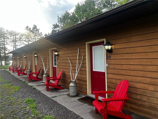 view of exterior entry featuring a patio