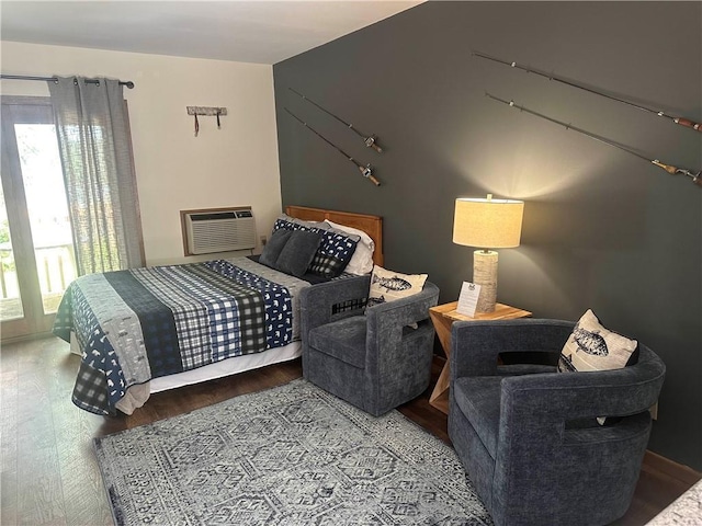 bedroom featuring an AC wall unit and wood finished floors