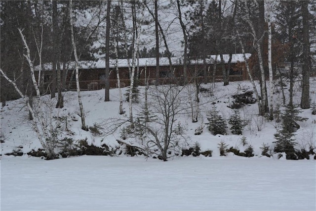 yard layered in snow with fence