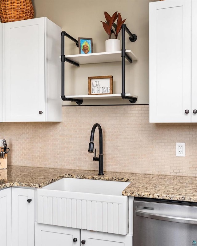 kitchen with open shelves, white cabinetry, dishwasher, and a sink