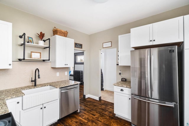 kitchen with open shelves, a sink, tasteful backsplash, stainless steel appliances, and white cabinets