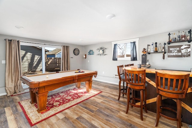 game room with billiards, a dry bar, wood finished floors, and baseboards