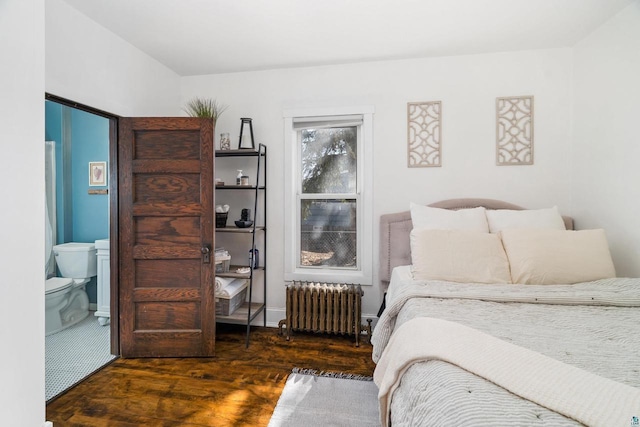 bedroom featuring radiator heating unit, wood finished floors, and ensuite bathroom