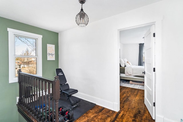 workout room with wood finished floors and baseboards