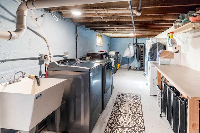 washroom featuring laundry area, washer and dryer, and a sink