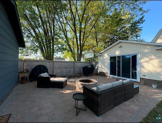 view of patio featuring an outdoor living space with a fire pit and a fenced backyard