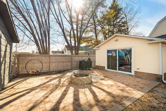 view of patio with a grill, a fenced backyard, and a fire pit