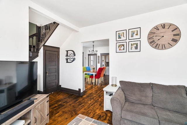 living area with baseboards, a chandelier, stairway, lofted ceiling with beams, and dark wood-style flooring