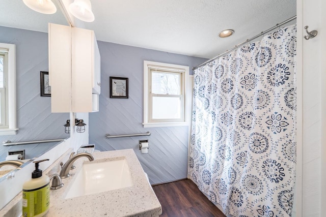 bathroom with a shower with shower curtain, a textured ceiling, vanity, and wood finished floors