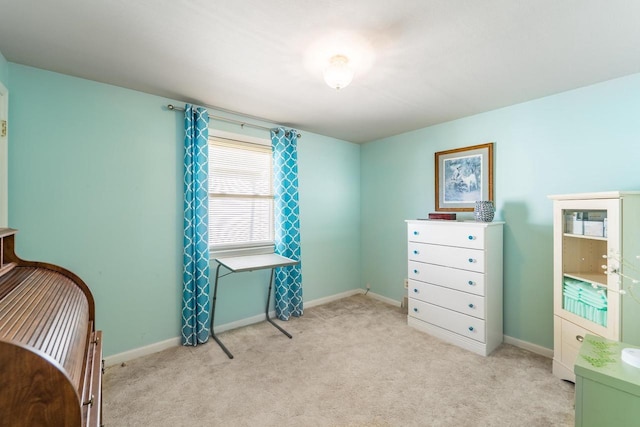 bedroom with baseboards and light carpet