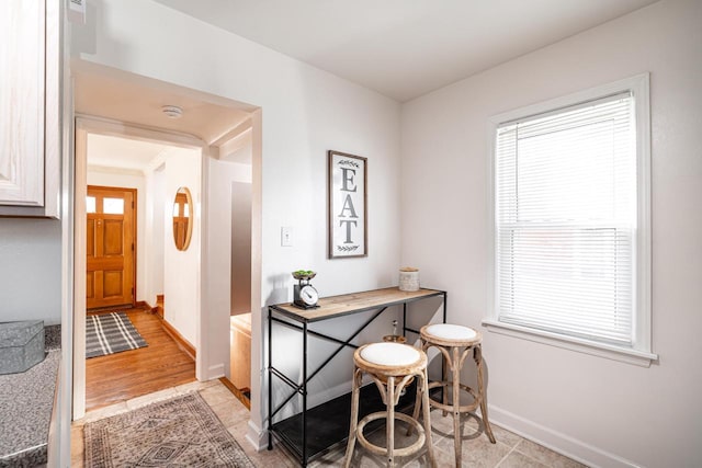 office space with baseboards and a healthy amount of sunlight