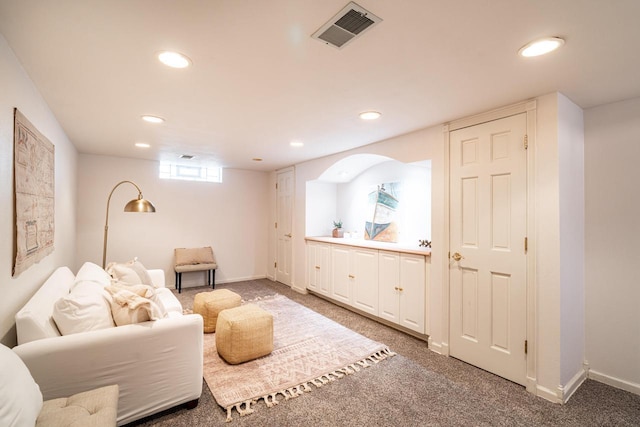 living room with baseboards, recessed lighting, visible vents, and light carpet