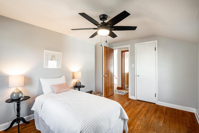 bedroom with lofted ceiling, wood finished floors, baseboards, and ceiling fan