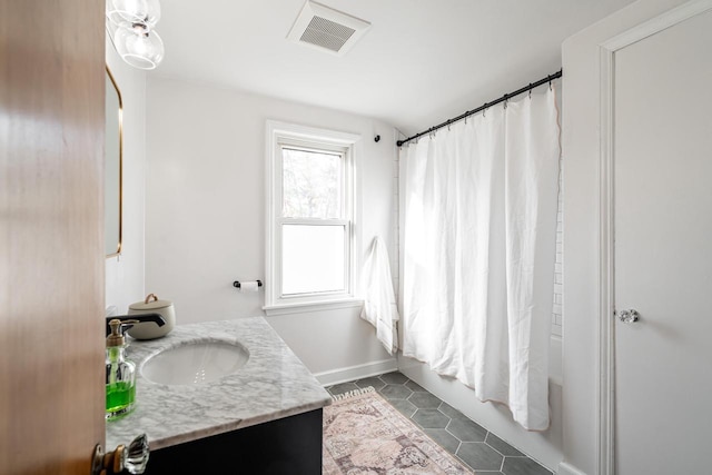 bathroom featuring vanity, visible vents, baseboards, shower / bath combo, and tile patterned floors