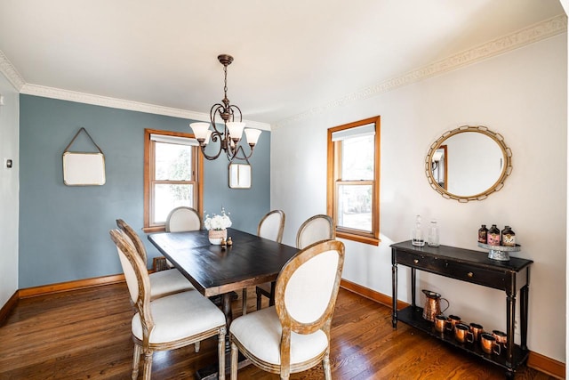 dining room featuring baseboards, an inviting chandelier, wood finished floors, and crown molding