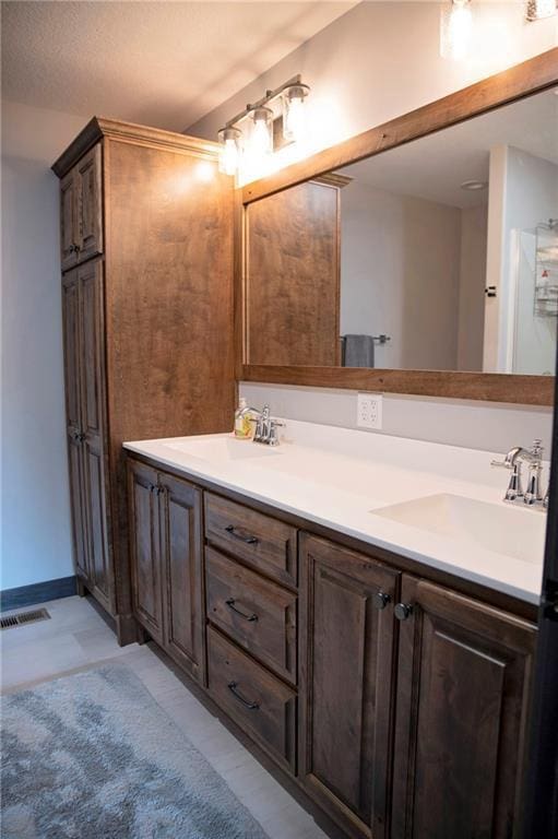 full bath with double vanity and a sink