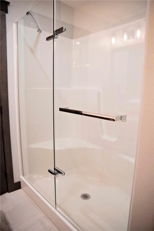 full bath featuring a shower stall