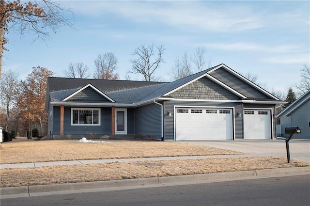 view of front of property with concrete driveway and an attached garage